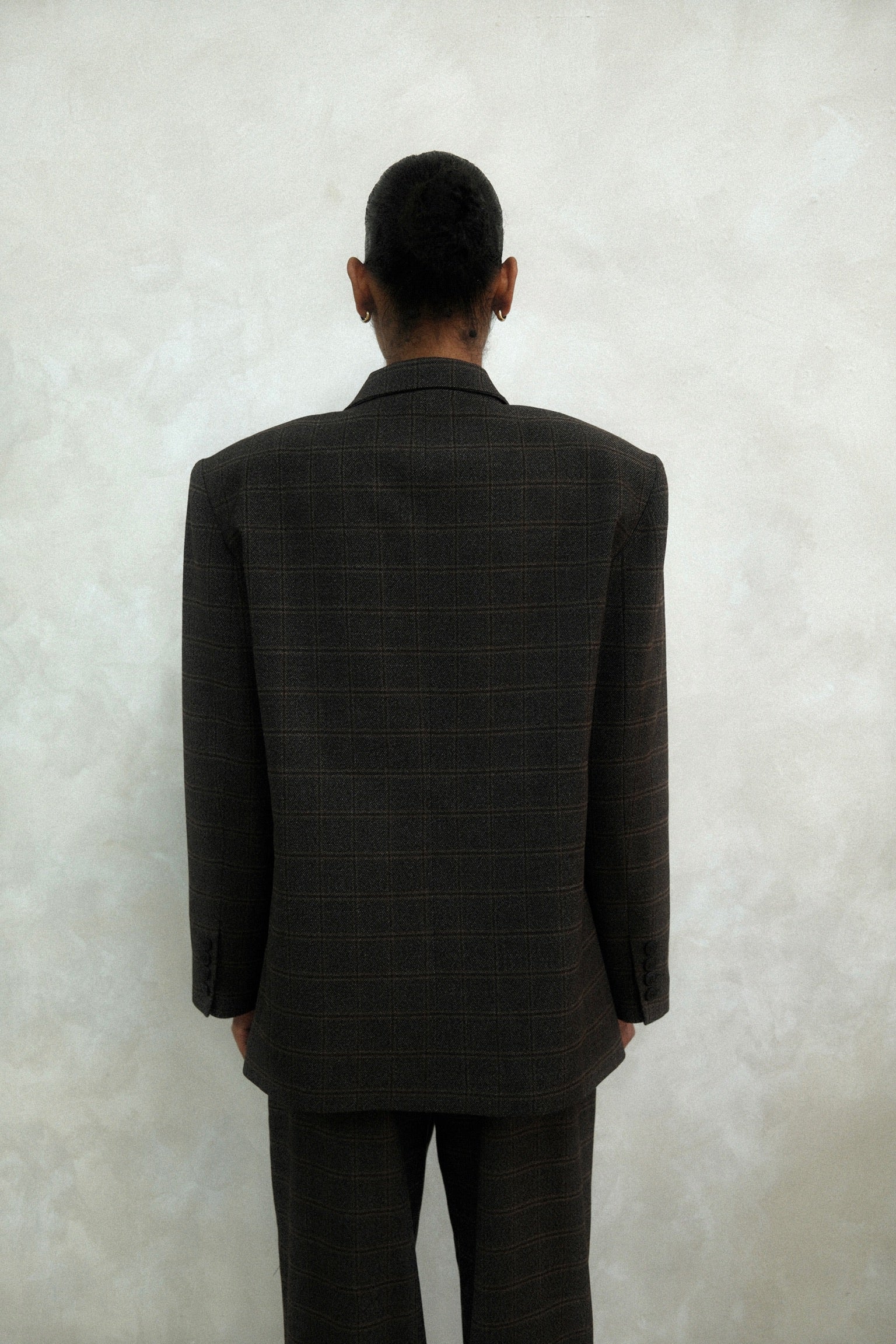 Back view of brown windowpane plaid Archer Blazer showing tailored construction and windowpane check pattern, styled with matching pants