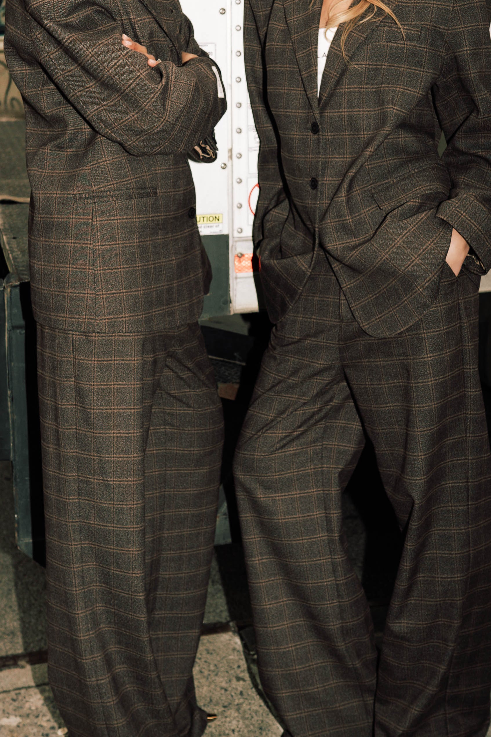 Close-up detail of brown windowpane plaid Carter Blazer and matching pants showing windowpane check pattern, styled with white t-shirt